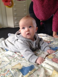 A four months old baby looking at things in movement