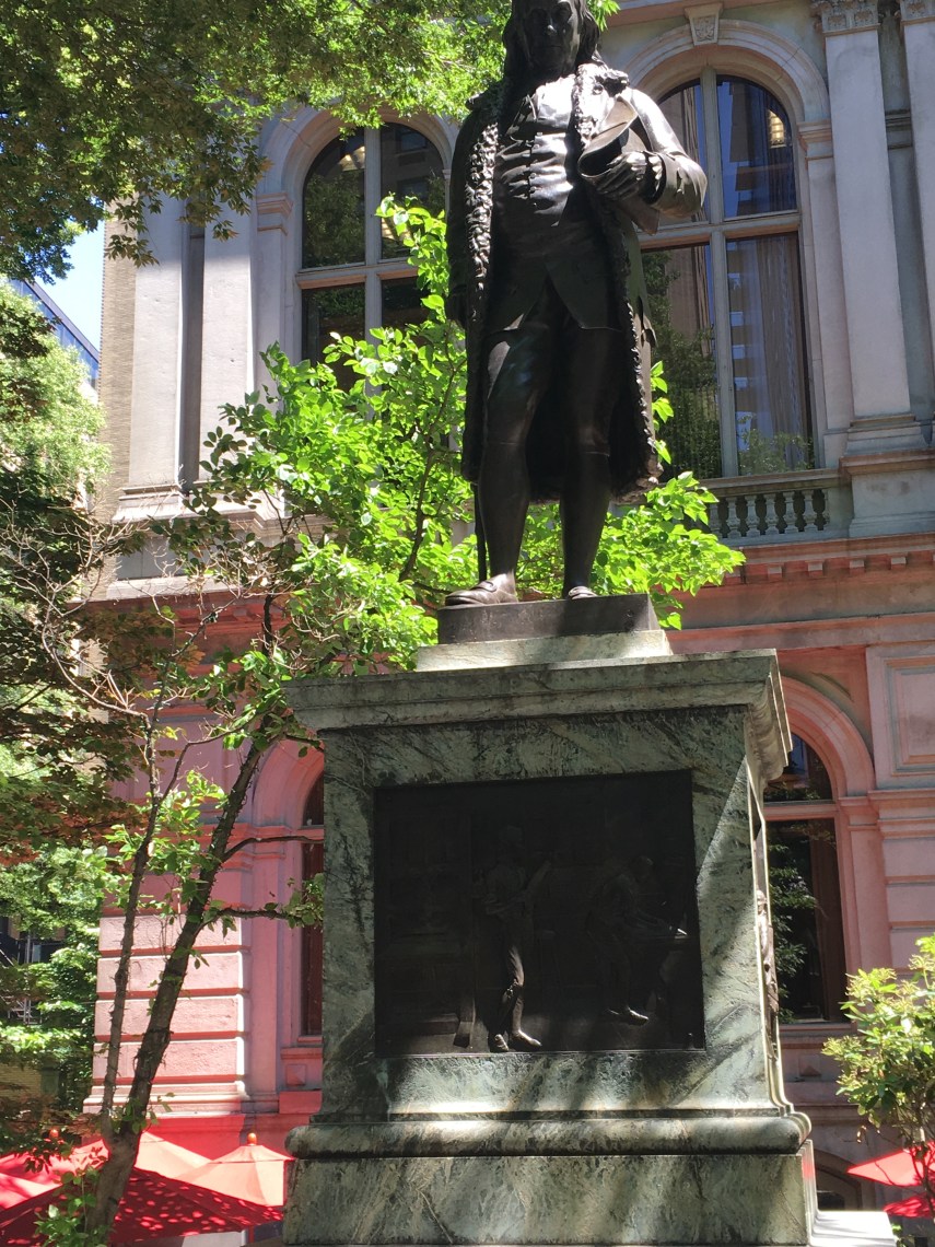 A statue of Benjamin Franklin where his old Latin School once was