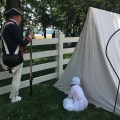 A soldier and his child acting as Washington’s Army