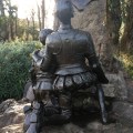 Don Quixote and Sancho Panza kneeling seen from&nbsp;behind